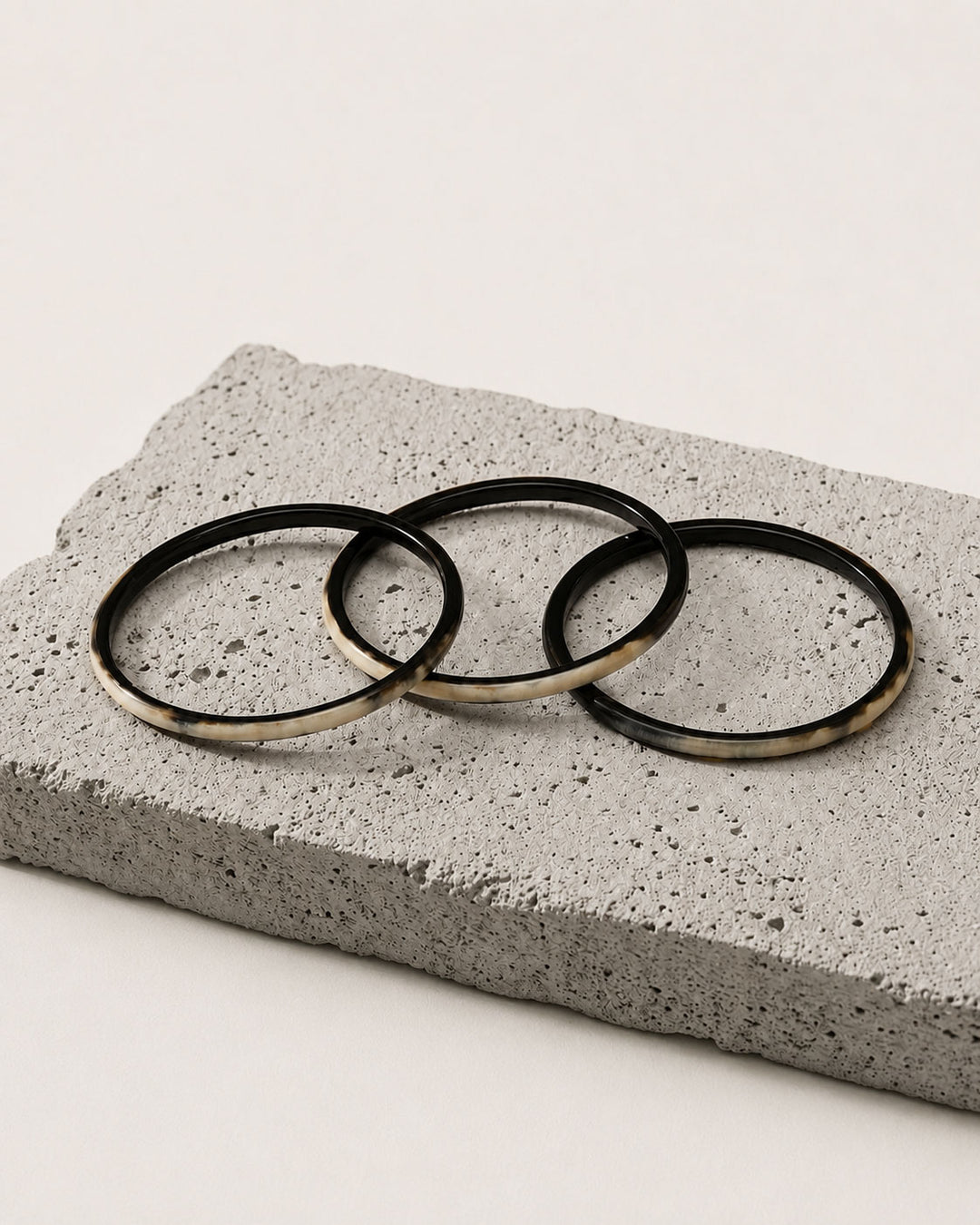Zuri black natural buffalo horn set of three slim stacking bangles photographed for Branch Jewellery