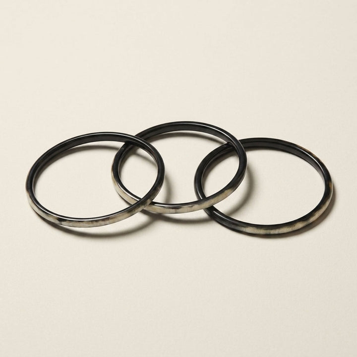 Zuri black natural buffalo horn set of three slim stacking bangles photographed for Branch Jewellery