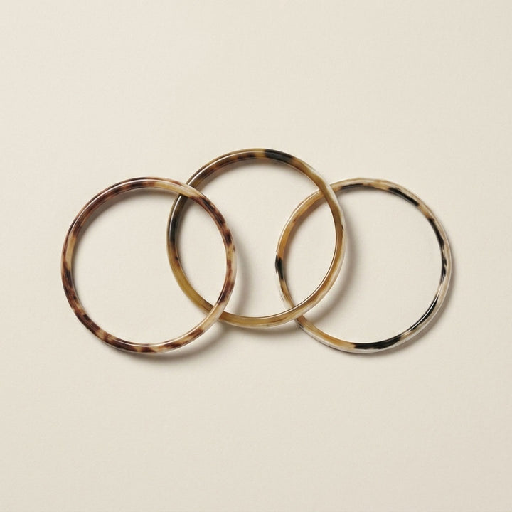Zuri white natural buffalo horn set of three slim stacking bangles photographed for Branch Jewellery