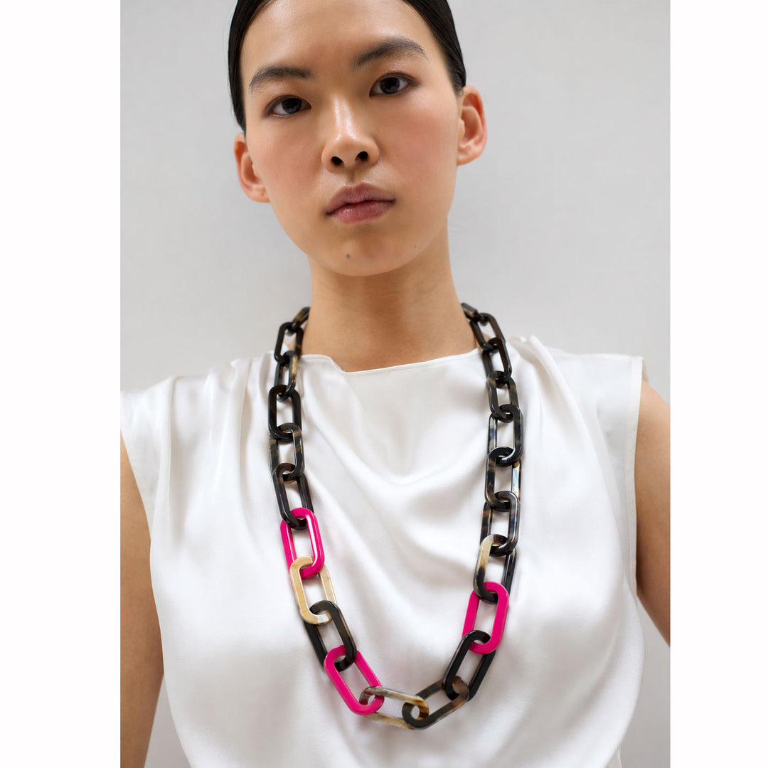 The Bright Fuchsia Pink and Black Natural Large Rectangle Link Necklace by Branch Jewellery is handmade with interlocking links in black, tan, brown, and pink, featuring a toggle clasp for easy wear.