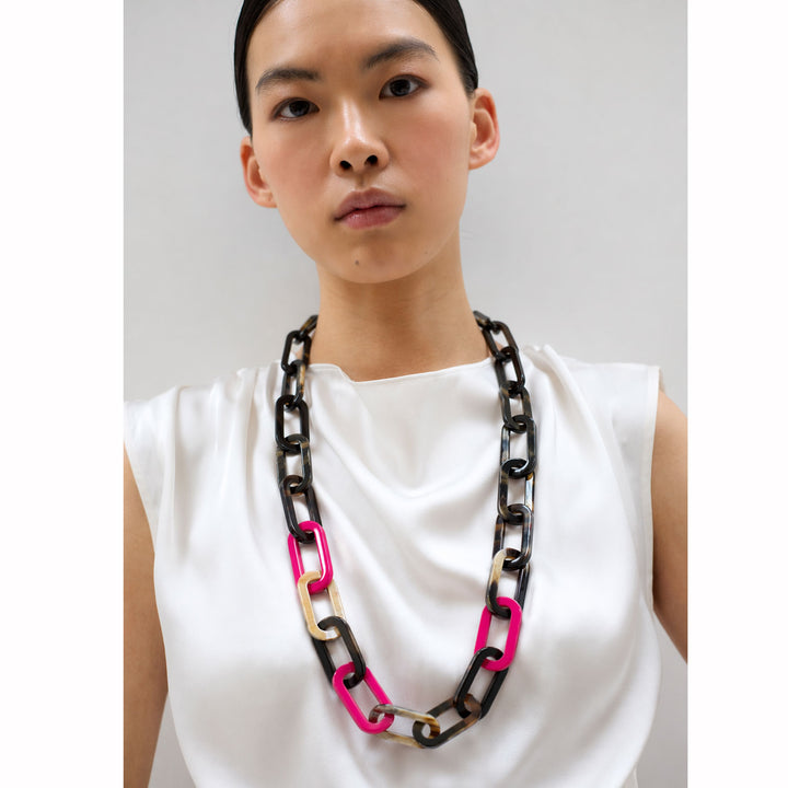 The Bright Fuchsia Pink and Black Natural Large Rectangle Link Necklace by Branch Jewellery is handmade with interlocking links in black, tan, brown, and pink, featuring a toggle clasp for easy wear.