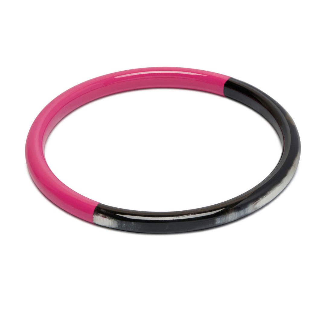 Branch Jewellery slim rounded black natural horn bangle with Fuchsia Pink Lacquer. Half of the bangle is natural black horn and half is covered in a smooth Fuchsia Pink lacquer.