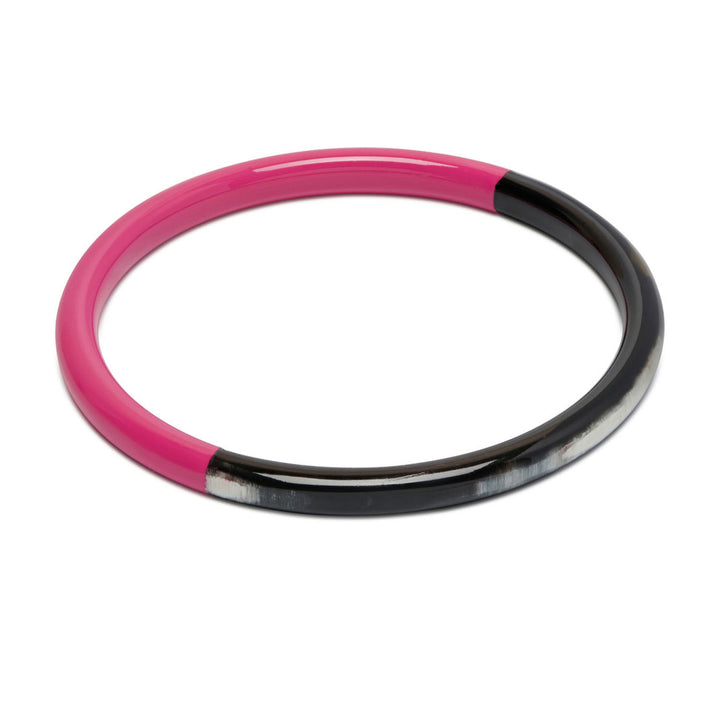 Branch Jewellery slim rounded black natural horn bangle with Fuchsia Pink Lacquer. Half of the bangle is natural black horn and half is covered in a smooth Fuchsia Pink lacquer.