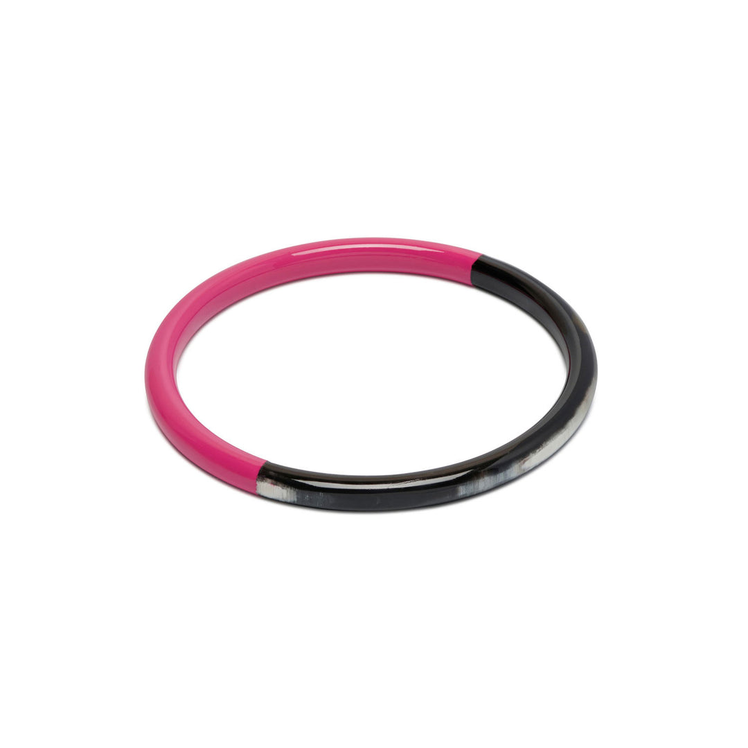 Branch Jewellery slim rounded black natural horn bangle with Fuchsia Pink Lacquer. Half of the bangle is natural black horn and half is covered in a smooth Fuchsia Pink lacquer.