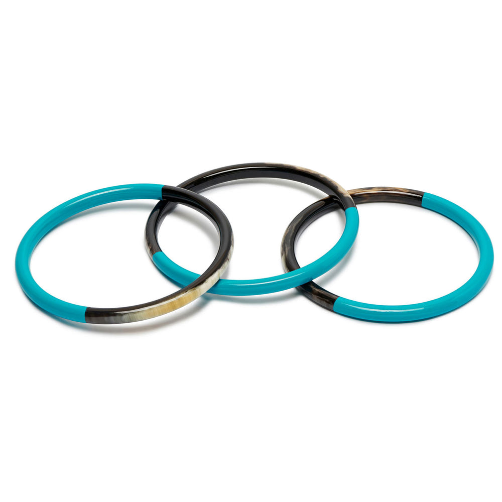 Branch Jewellery set of three slim rounded bangles made from naurtal buffalo horn and Turquoise Blue lacquered horn.  Half of the bangle is black natural horn with natural markings and colourings and the other half is covered with a smooth Turquoise Blue lacquer.