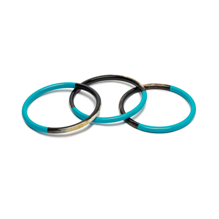 Branch Jewellery set of three slim rounded bangles made from naurtal buffalo horn and Turquoise Blue lacquered horn.  Half of the bangle is black natural horn with natural markings and colourings and the other half is covered with a smooth Turquoise Blue lacquer.