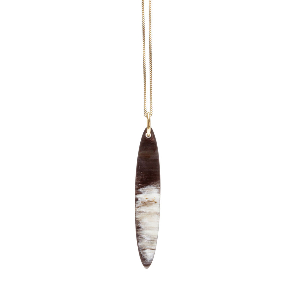 Branch Jewellery - long red and black natural reversable oval horn pendant on a gold plated silver chain.