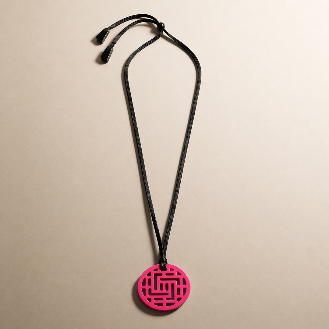 Branch Jewellery Moko Geometric Patterned Fuschia Pink Round cut-out Horn Pendant on black adjustable cord.