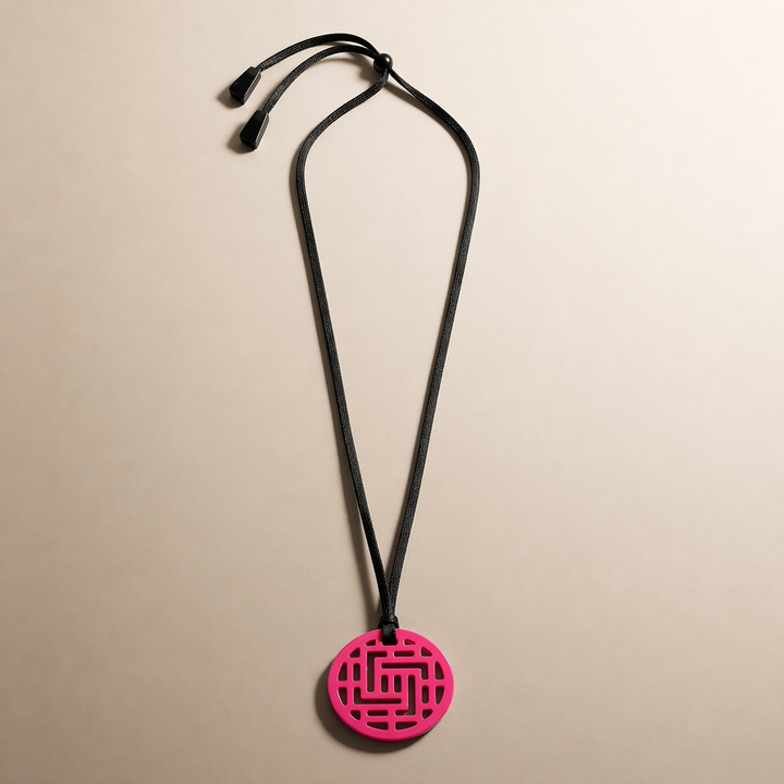 Branch Jewellery Moko Geometric Patterned Fuschia Pink Round cut-out Horn Pendant on black adjustable cord.