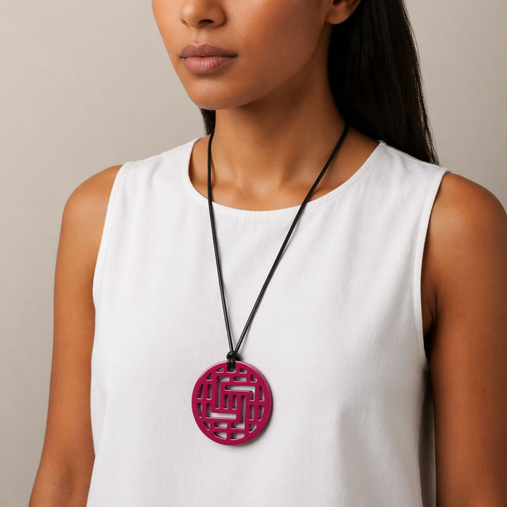 Branch Jewellery Moko Geometric Patterned Fuschia Pink Round cut-out Horn Pendant on black adjustable cord.