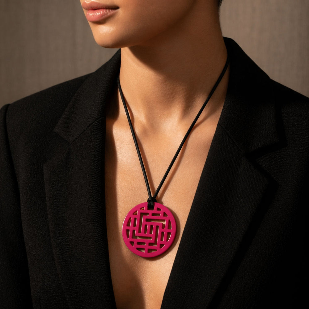 Branch Jewellery Moko Geometric Patterned Fuschia Pink Round cut-out Horn Pendant on black adjustable cord.