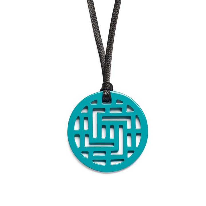 Branch Jewellery Moko Geometric Patterned Turquoise Blue Round cut-out Horn Pendant on black adjustable cord.