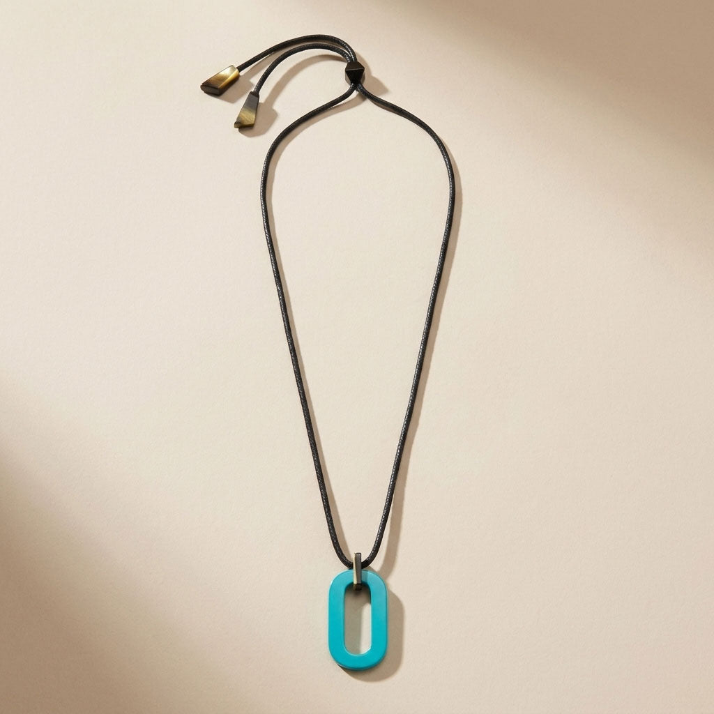 Branch Jewellery Moko Geometric Patterned Turquoise Blue Round cut-out Horn Pendant on black adjustable cord.