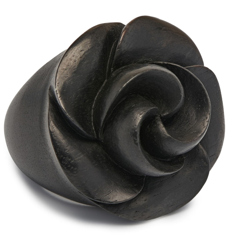 Close-up of intricate hand-carved black wooden rose ring petals