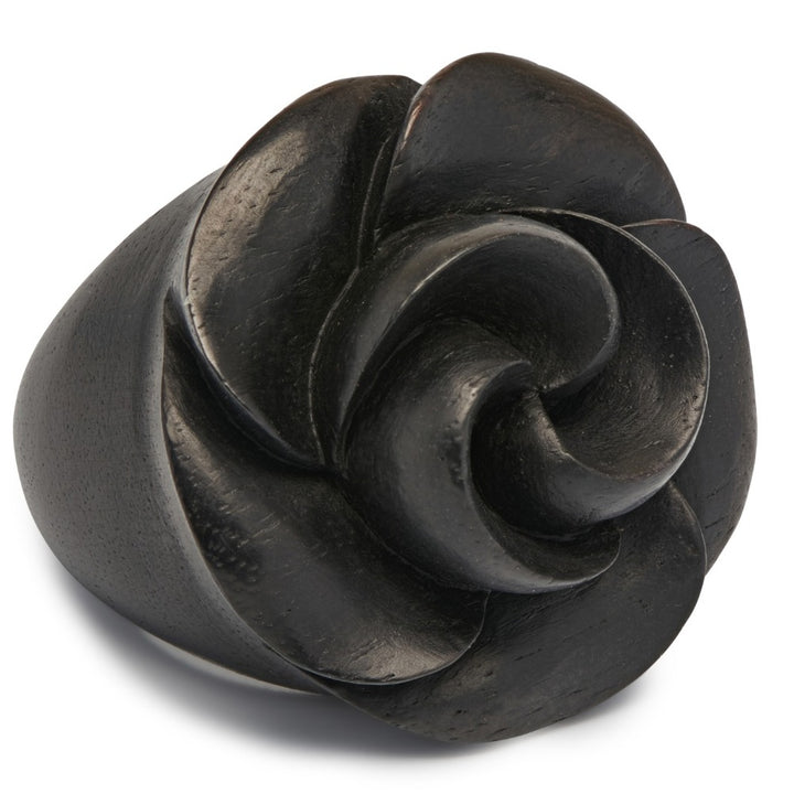 Close-up of intricate hand-carved black wooden rose ring petals