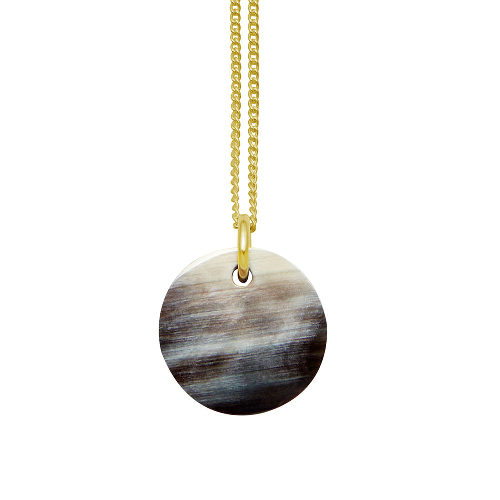 Branch Jewellery - small round black natural horn disc pendant on a gold plated silver chain.