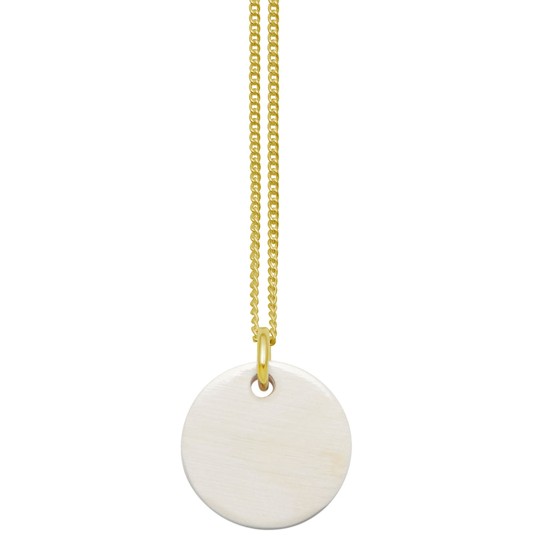 Branch Jewellery - small round white natural horn disc pendant on a gold plated silver chain.